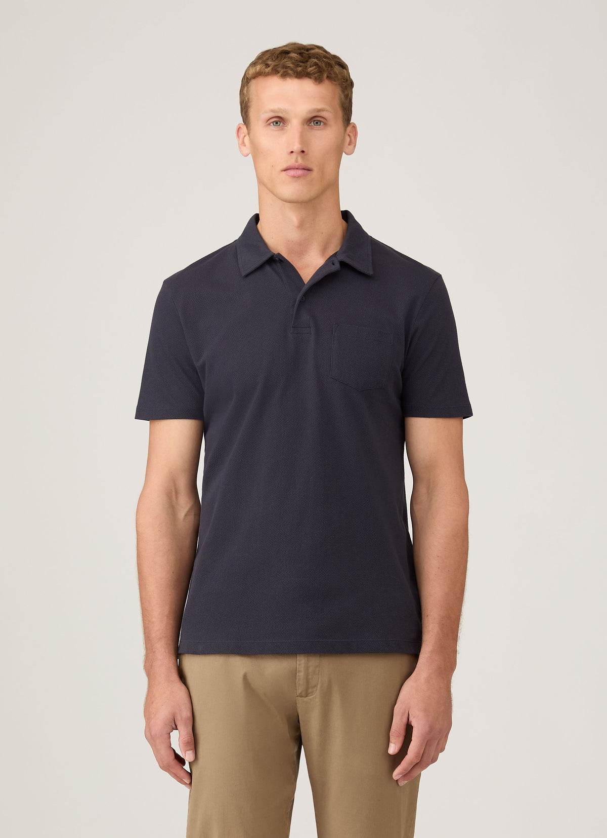 Sunspel Riviera Polo in navy — worn front view